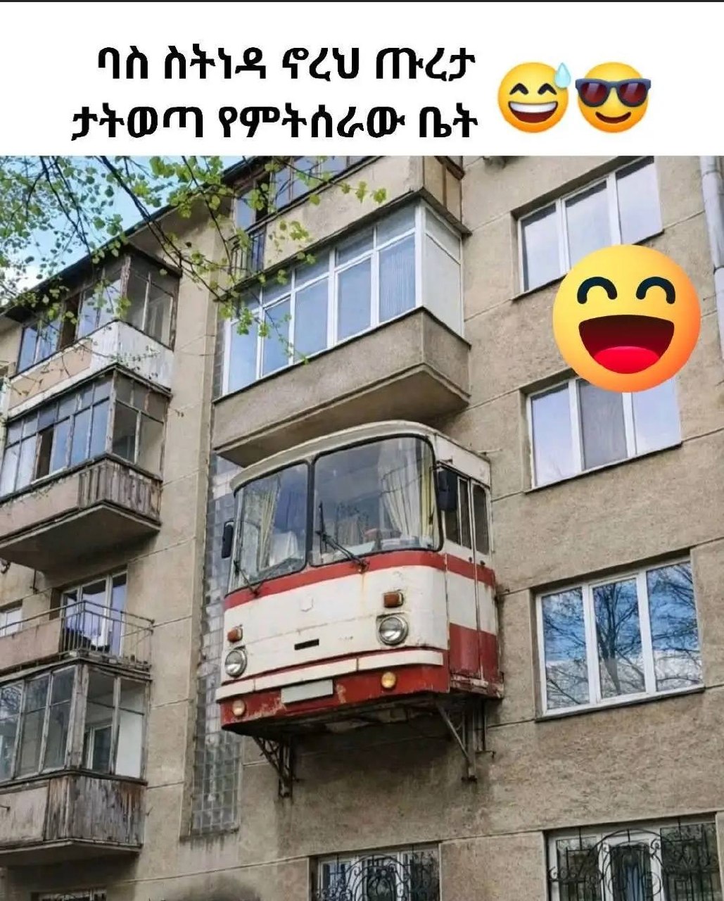 a red and white tram car is parked in front of a building